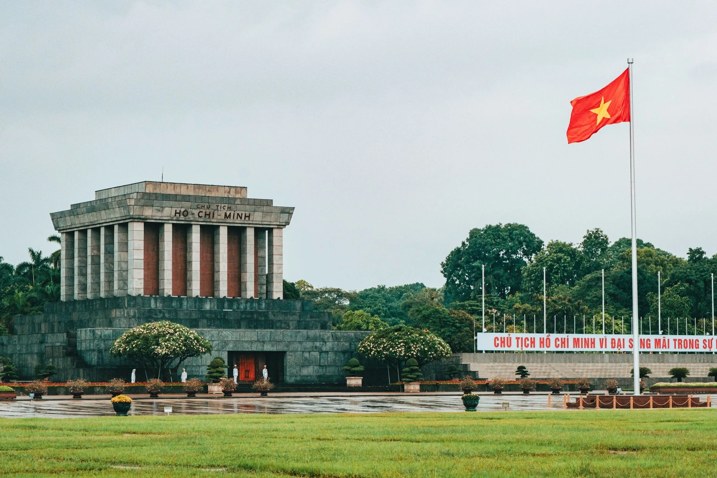 Ho Chi Minh Mausoleum and a Vietnamese flag on Ba Dinh Square, Hanoi