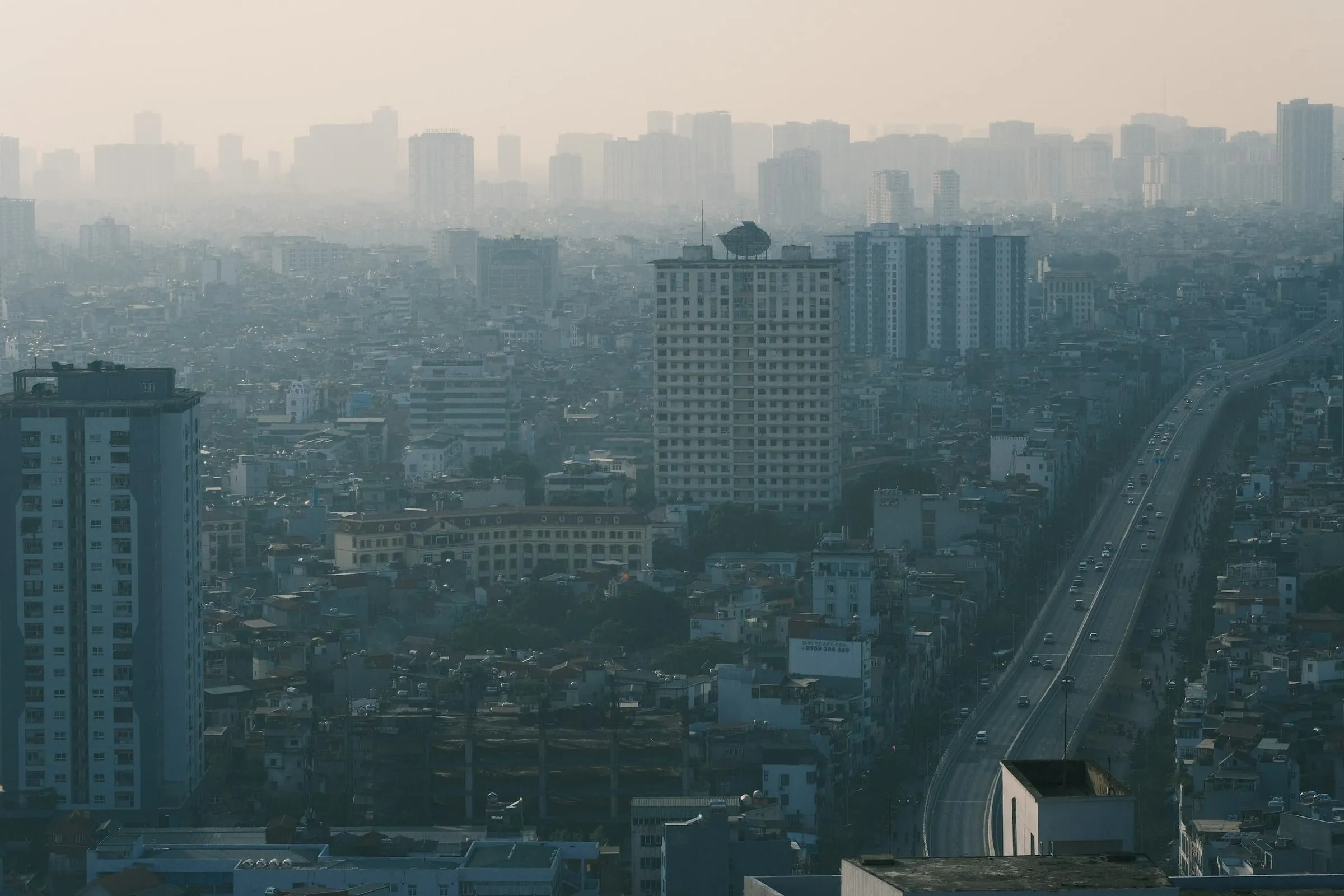 Hanoi's high-rises and an elevated road in thick haze