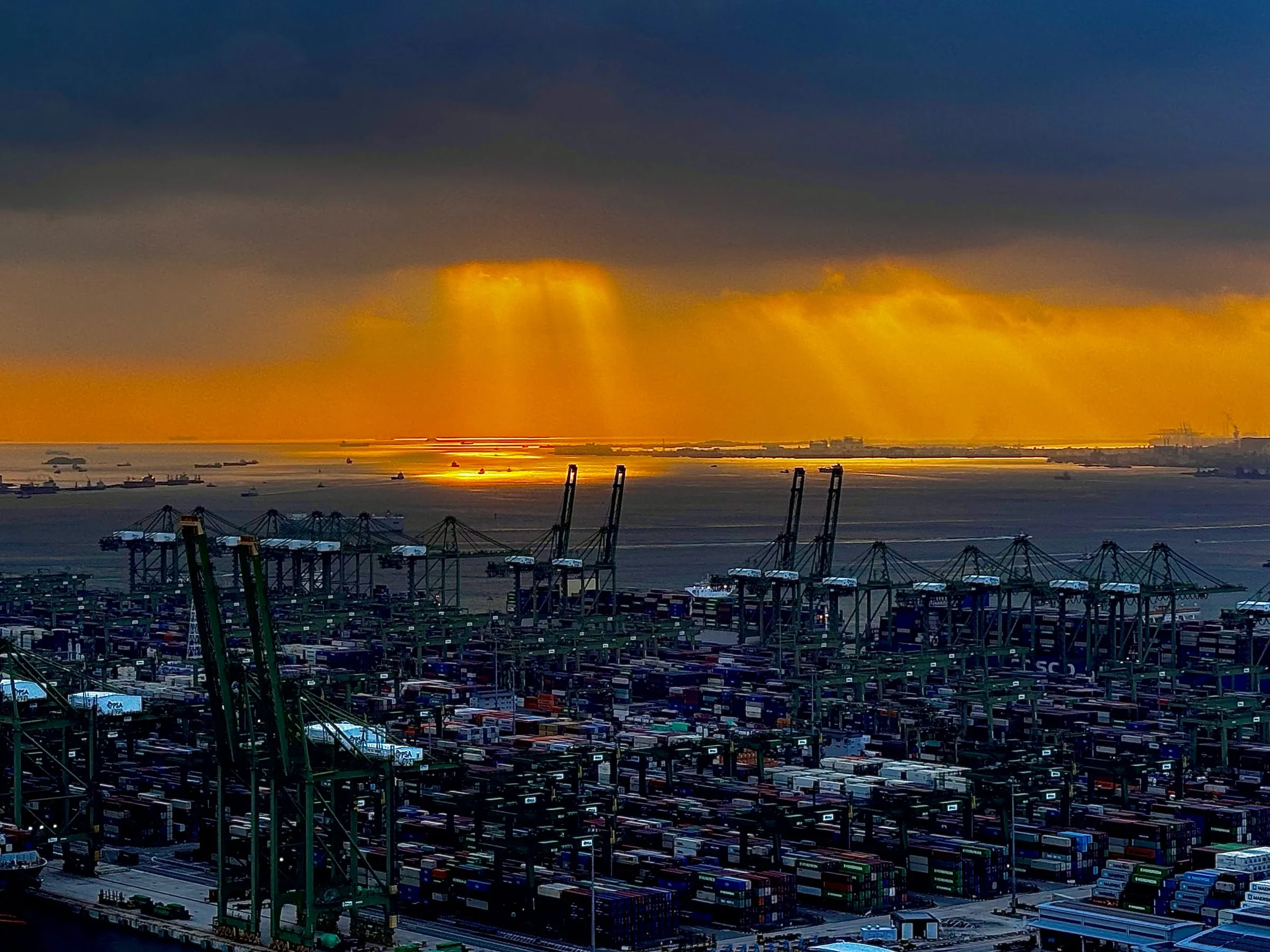 Light breaking through clouds over Pasir Panjang Container Terminal, Singapore