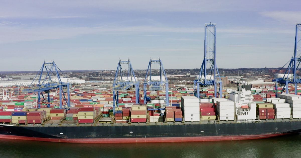 Aerial view of gantry cranes beside a container ship at a port