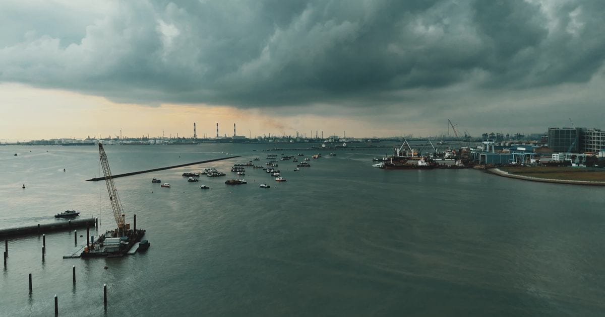 Dark storm clouds over boats moored in a harbour in Singapore